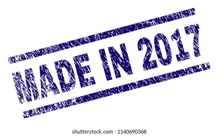 MADE IN 2017 stamp seal watermark with distress style. Blue vector rubber print of MADE IN 2017 text with unclean texture. Text caption is placed between parallel lines.