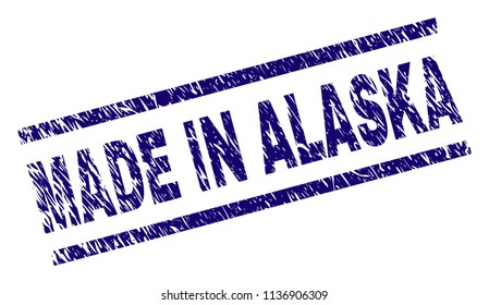 MADE IN ALASKA stamp seal watermark with distress style. Blue vector rubber print of MADE IN ALASKA text with dirty texture. Text label is placed between parallel lines.