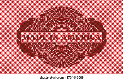 Made in America text inside red checkered tablecloth realistic emblem. Restaurant handsome background. Intense illustration. 