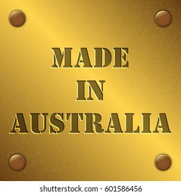 made in Australia text on gold metal plate with bolts in corners, Golden texture