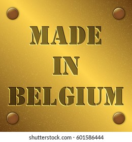 made in Belgium text on gold metal plate with bolts in corners, Golden texture