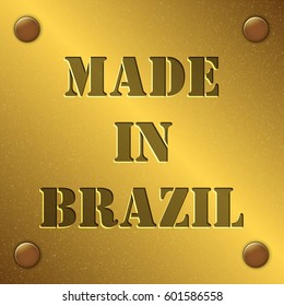 made in Brazil text on gold metal plate with bolts in corners, Golden texture