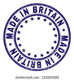 MADE IN BRITAIN stamp seal imprint with distress texture. Designed with circles and stars. Blue vector rubber print of MADE IN BRITAIN title with scratched texture.