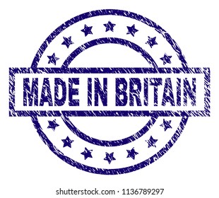 MADE IN BRITAIN stamp seal watermark with distress texture. Designed with rectangle, circles and stars. Blue vector rubber print of MADE IN BRITAIN caption with scratched texture.