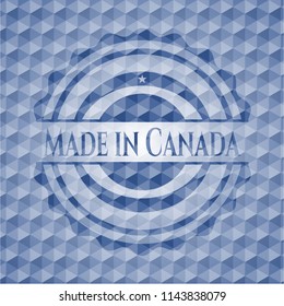 Made in Canada blue emblem or badge with abstract geometric pattern background.