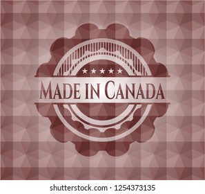 Made in Canada red emblem or badge with abstract geometric polygonal pattern background. Seamless.