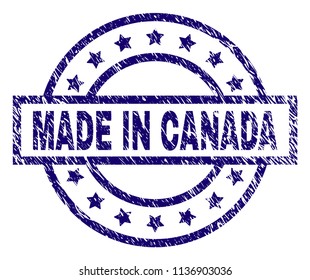 MADE IN CANADA stamp seal watermark with grunge texture. Designed with rectangle, circles and stars. Blue vector rubber print of MADE IN CANADA caption with retro texture.