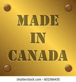 made in Canada text on gold metal plate with bolts in corners, Golden texture