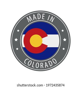 Made in Colorado icon. Gray stamp with a round state flag.