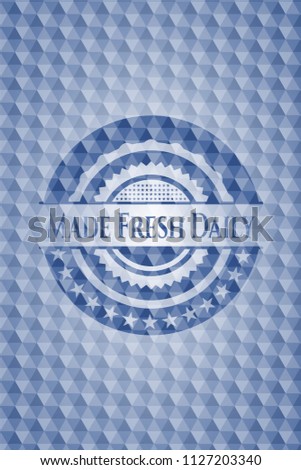 Made Fresh Daily blue emblem with geometric background.