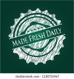 Made Fresh Daily chalk emblem written on a blackboard