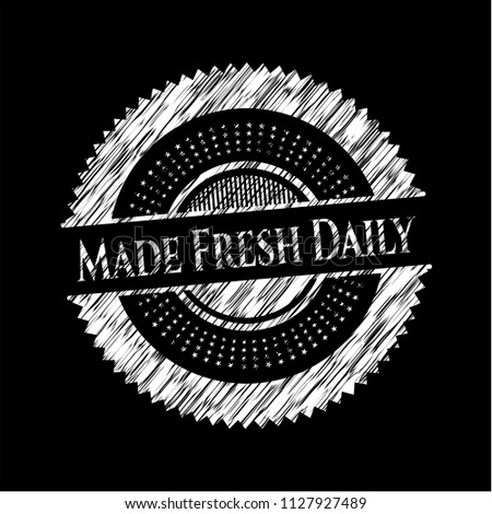 Made Fresh Daily chalk emblem written on a blackboard