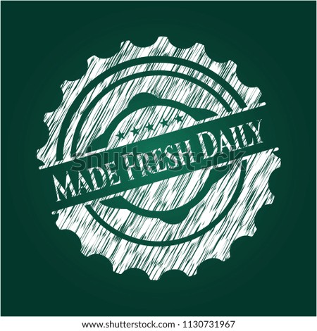 Made Fresh Daily chalk emblem written on a blackboard