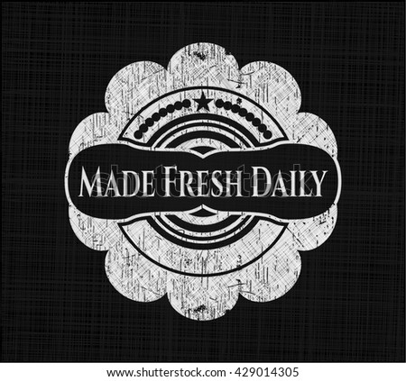 Made Fresh Daily chalk emblem written on a blackboard