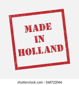 made in Holland text rubber seal stamp watermark. Caption inside rounded rectangular banner with grunge design and dirty texture. Slanted vector ink sticker on paper background.