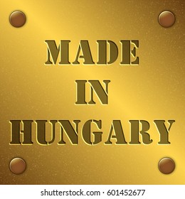 made in Hungary text on gold metal plate with bolts in corners, Golden texture