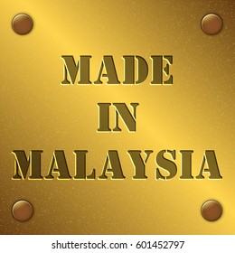 made in Malaysia text on gold metal plate with bolts in corners, Golden texture