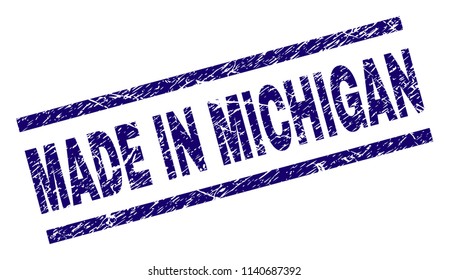 MADE IN MICHIGAN stamp seal watermark with distress style. Blue vector rubber print of MADE IN MICHIGAN caption with dirty texture. Text caption is placed between parallel lines.