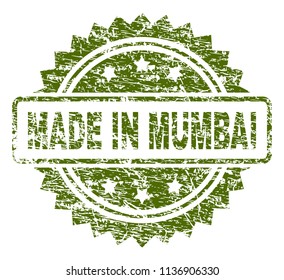 MADE IN MUMBAI stamp seal watermark with rubber print style. Green vector rubber print of MADE IN MUMBAI title with scratched texture.
