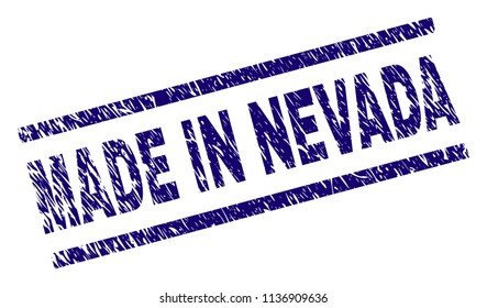 MADE IN NEVADA stamp seal watermark with grunge style. Blue vector rubber print of MADE IN NEVADA tag with retro texture. Text tag is placed between parallel lines.