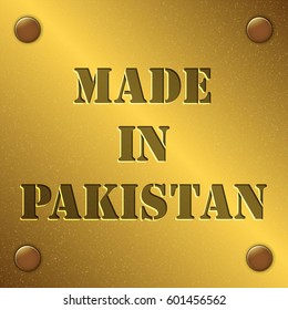 made in Pakistan text on gold metal plate with bolts in corners, Golden texture