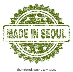 MADE IN SEOUL stamp seal watermark with rubber print style. Green vector rubber print of MADE IN SEOUL label with scratched texture.