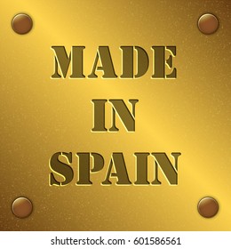 made in Spain text on gold metal plate with bolts in corners, Golden texture