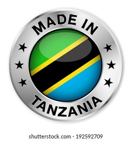 Made in Tanzania silver badge and icon with central glossy Tanzanian flag symbol and stars. Vector EPS10 illustration isolated on white background.