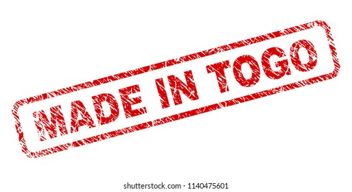 MADE IN TOGO stamp seal print with distress style. Red vector rubber print of MADE IN TOGO text with retro texture. Text label is placed inside rounded rectangle frame.