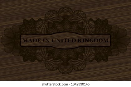 Texto hecho en el Reino Unido dentro del emblema de madera de Guilloche. Fondo de fantasía marrón. Ilustración. 