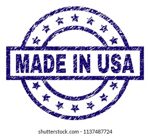 MADE IN USA stamp seal watermark with distress texture. Designed with rectangle, circles and stars. Blue vector rubber print of MADE IN USA title with scratched texture.