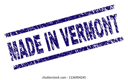 MADE IN VERMONT stamp seal watermark with scratced style. Blue vector rubber print of MADE IN VERMONT text with grunge texture. Text caption is placed between parallel lines.