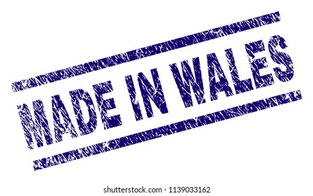 MADE IN WALES stamp seal watermark with scratced style. Blue vector rubber print of MADE IN WALES text with scratched texture. Text tag is placed between parallel lines.