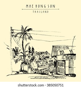 Maehongson, Thailand, Southeast Asia. City center. Traditional Northern Thai wooden house, palm trees, electric wires. Artistic postcard banner poster template with hand lettering