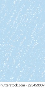Magic falling snow christmas background. Subtle flying snow flakes and stars on light blue winter backdrop. Magic falling snow holiday scenery.   Vertical vector illustration.