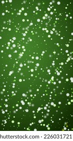 Magic falling snow christmas background. Subtle flying snow flakes and stars on christmas green background. Magic falling snow holiday scenery.   Vertical vector illustration.