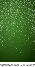 Magic falling snow christmas background. Subtle flying snow flakes and stars on christmas green background. Magic falling snow holiday scenery. Vertical vector illustration.