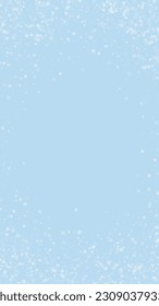 Magic falling snow christmas background. Subtle flying snow flakes and stars on light blue winter backdrop. Magic falling snow holiday scenery.   Vertical vector illustration.