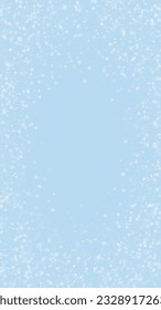 Magic falling snow christmas background. Subtle flying snow flakes and stars on light blue winter backdrop. Magic falling snow holiday scenery.   Vertical vector illustration.