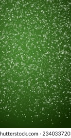 Magic falling snow christmas background. Subtle flying snow flakes and stars on christmas green background. Magic falling snow holiday scenery.   Vertical vector illustration.