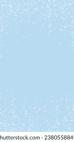 Magic falling snow christmas background. Subtle flying snow flakes and stars on light blue winter backdrop. Magic falling snow holiday scenery.   Vertical vector illustration.