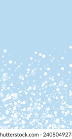 Magic falling snow christmas background. Subtle flying snow flakes and stars on light blue winter backdrop. Magic falling snow holiday scenery.   Vertical vector illustration.