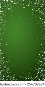 Magic falling snow christmas background. Subtle flying snow flakes and stars on christmas green background. Magic falling snow holiday scenery.   Vertical vector illustration.