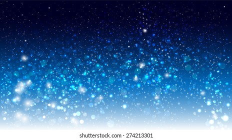 Magic glow and bokeh on a blue background. Christmas background with falling snow