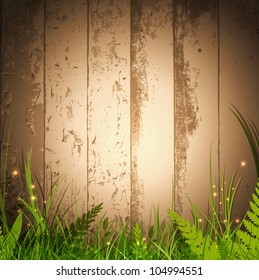 magic grass over wooden background with spotlight for your advertising