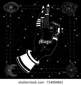 The magic hand of the buddha against the starry sky with the elements of wind, crystals, month, eye