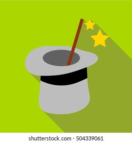 Magic hat and wand icon. Flat illustration of magic hat and wand vector icon for web isolated on green background
