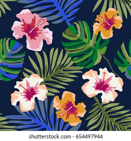 Magic Hawaiian night. Seamless vector pattern with palm leaves and hibiscus flowers on dark blue background. Beach textile design collection.