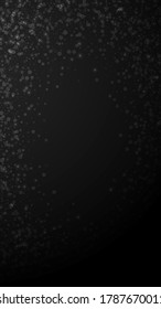 Magic stars Christmas background. Subtle flying snow flakes and stars on black background. Actual winter silver snowflake overlay template. Dramatic vertical illustration.