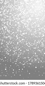 Magic stars Christmas background. Subtle flying snow flakes and stars on grey background. Appealing winter silver snowflake overlay template. Shapely vertical illustration.
